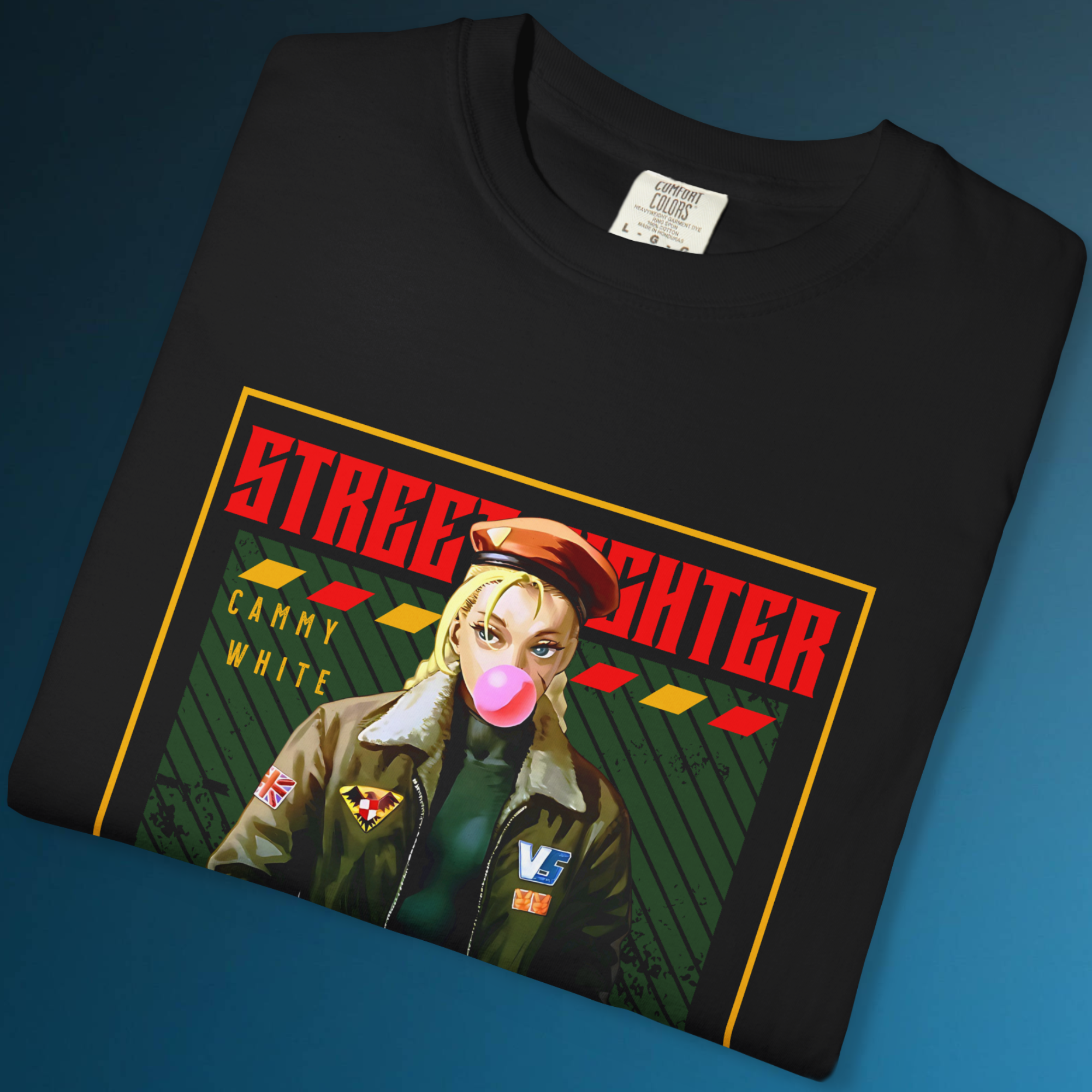 This Street Fighter Cammy White tee features her blowing gum and looking deadpan. Perfect for gamers, anime lovers, and retro arcade fashion enthusiasts.