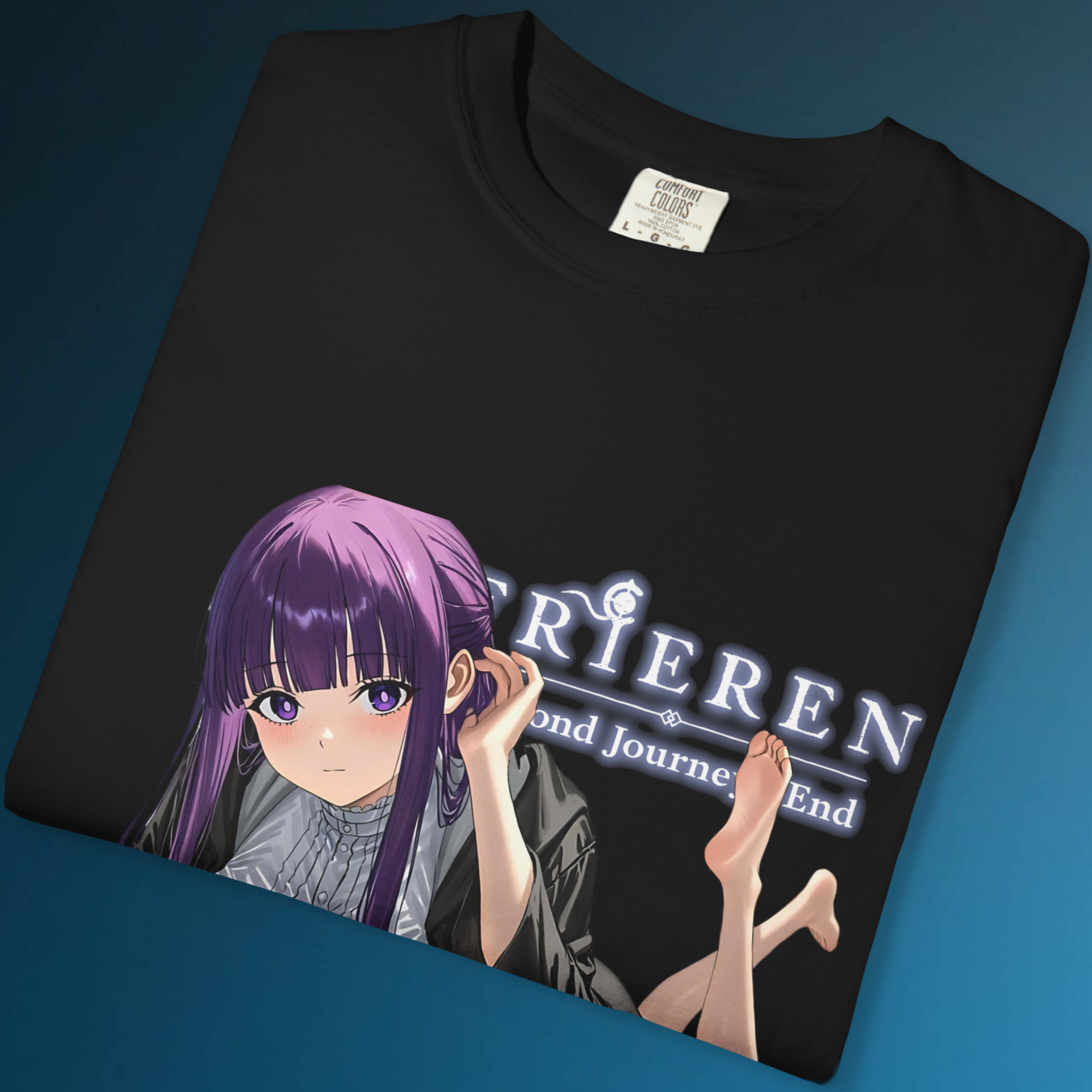 Close-up anime artwork of Fern in a lying pose with exposed soles and a magical expression, printed vividly on a dark background tee.