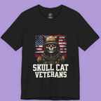 "Skull Cat Veterans T-shirt featuring a skull-faced cat soldier in a U.S. flag backdrop – patriotic gothic graphic tee on Bella+Canvas 3001."