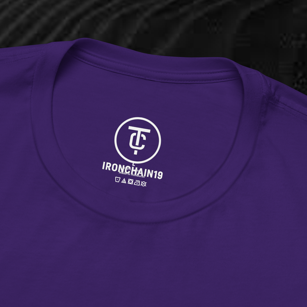 A close-up of the inside collar of a  cotton t-shirt from Ironchain 19. The tagless printed label features a sleek white logo with a chain illustration, surrounded by number19 . Below the logo, the text indicates the shirt is 100% cotton, made in Bangladesh, and includes washing care symbols. The soft fabric and seamless neckline highlight the premium quality and comfort of this Gothic aesthetics  perfect for cat lovers and fans of modern streetwear fashion.