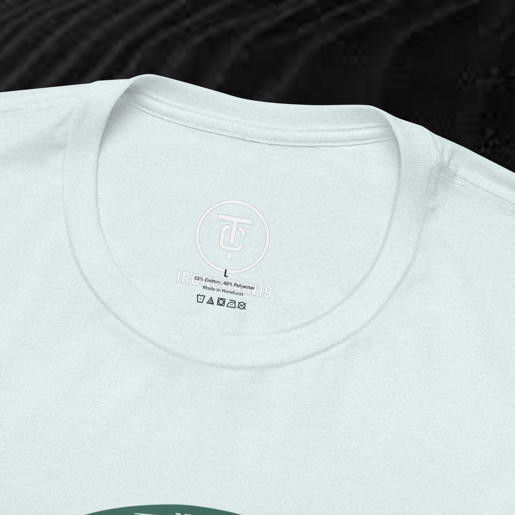 A close-up of the inside collar of a  cotton t-shirt from Ironchain 19. The tagless printed label features a sleek white logo with a chain illustration, surrounded by number19 . Below the logo, the text indicates the shirt is 100% cotton, made in Bangladesh, and includes washing care symbols. The soft fabric and seamless neckline highlight the premium quality and comfort of this Gothic aesthetics  perfect for cat lovers and fans of modern streetwear fashion.