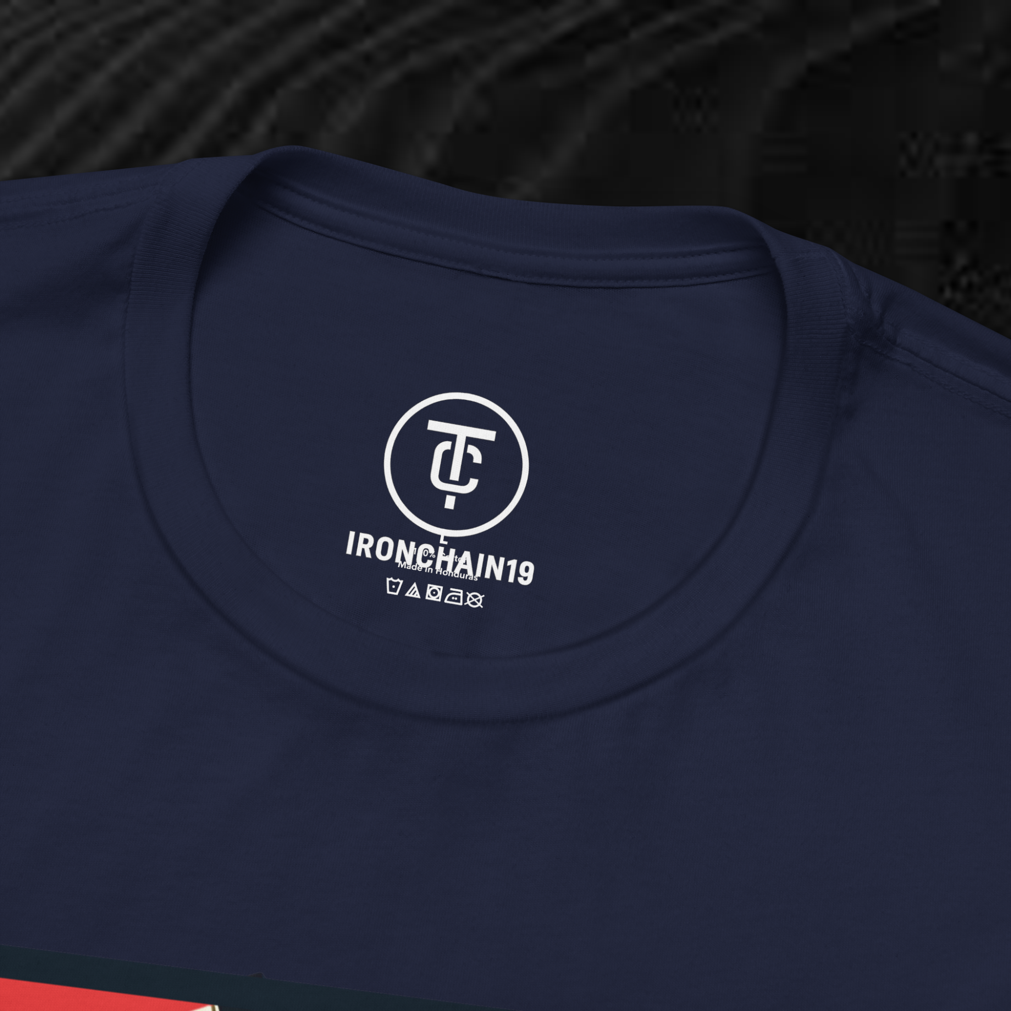 A close-up of the inside collar of a  cotton t-shirt from Ironchain 19. The tagless printed label features a sleek white logo with a chain illustration, surrounded by number19 . Below the logo, the text indicates the shirt is 100% cotton, made in Bangladesh, and includes washing care symbols. The soft fabric and seamless neckline highlight the premium quality and comfort of this Gothic aesthetics  perfect for cat lovers and fans of modern streetwear fashion.