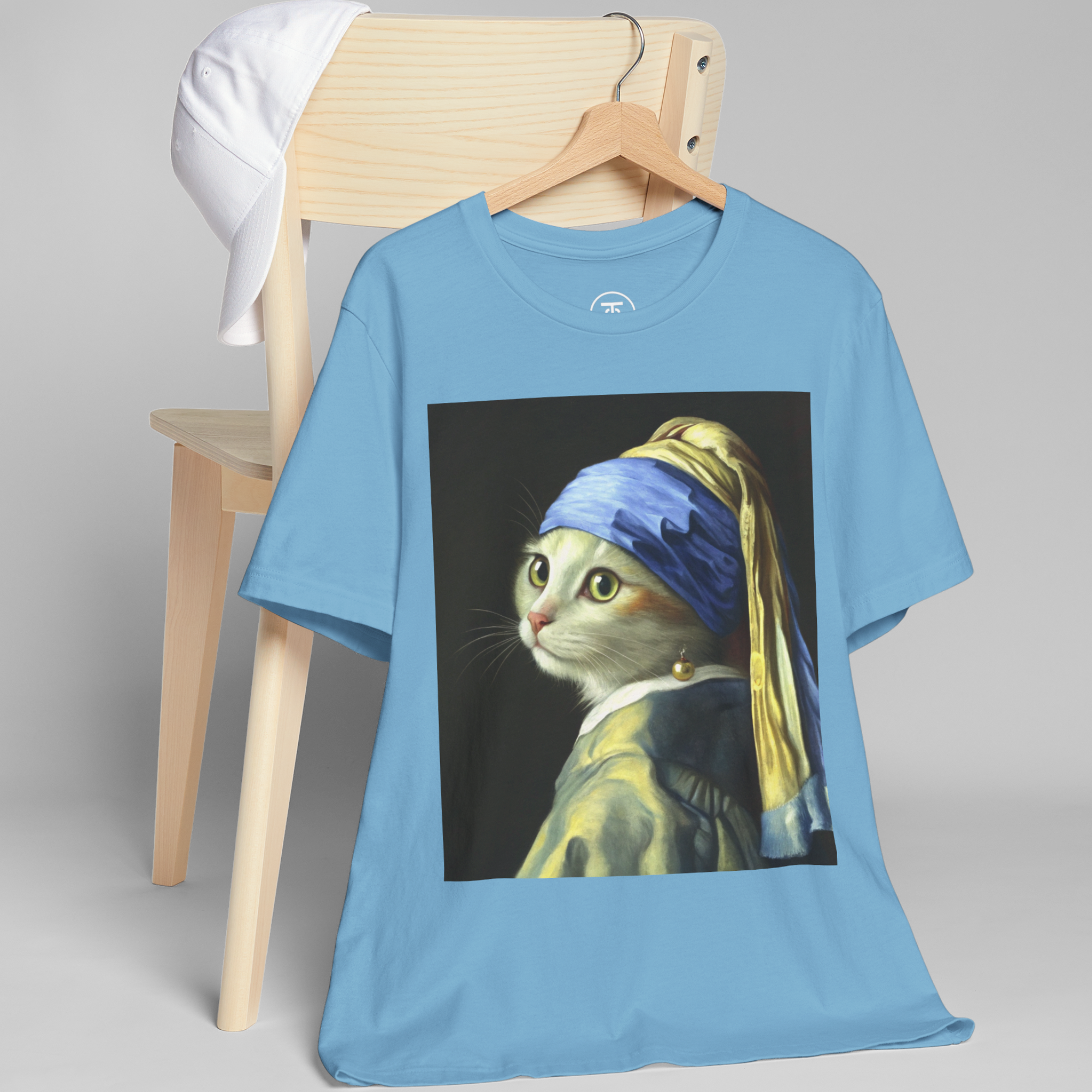The Vermeer Parody T-Shirt features a humorous design of a classic artwork hanging on a chair.