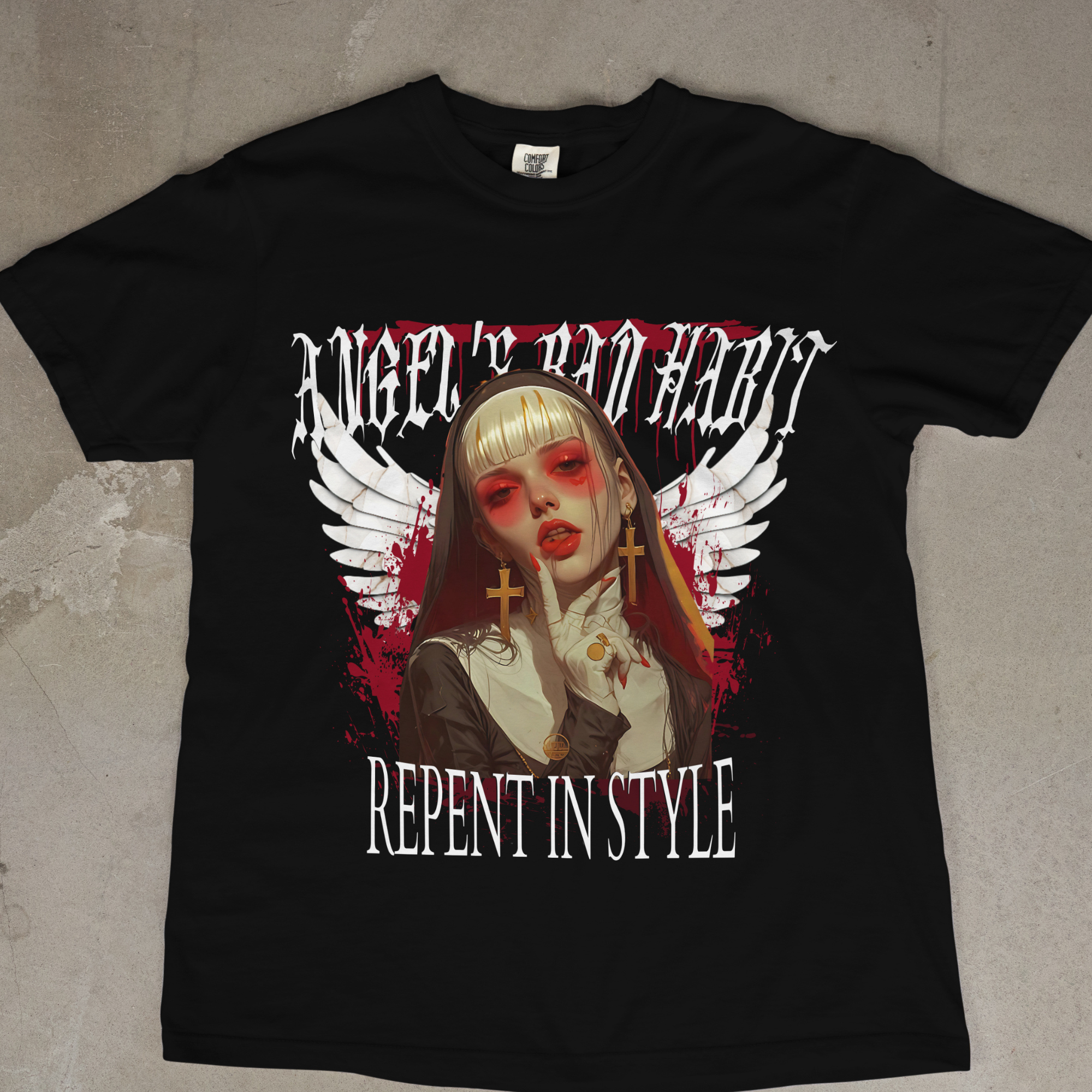 Close view of the nun's face and hands on the Angel's Bad Habit graphic tee, highlighting the cross jewelry.
