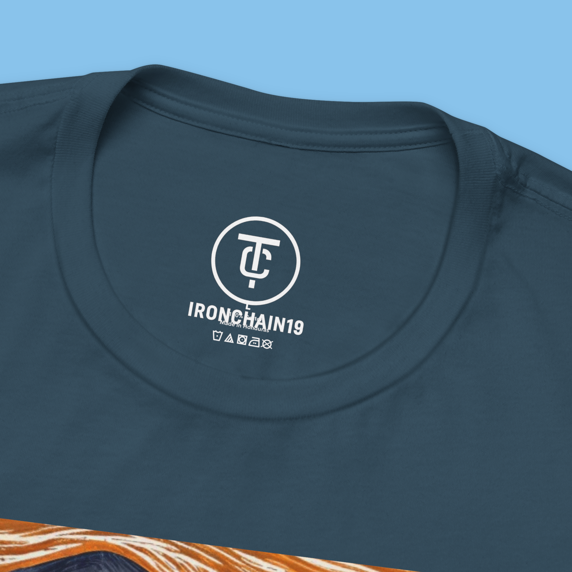 A close-up of the inside collar of a  cotton t-shirt from Ironchain 19. The tagless printed label features a sleek white logo with a chain illustration, surrounded by number19 . Below the logo, the text indicates the shirt is 100% cotton, made in Bangladesh, and includes washing care symbols. The soft fabric and seamless neckline highlight the premium quality and comfort of this Gothic aesthetics  perfect for cat lovers and fans of modern streetwear fashion.